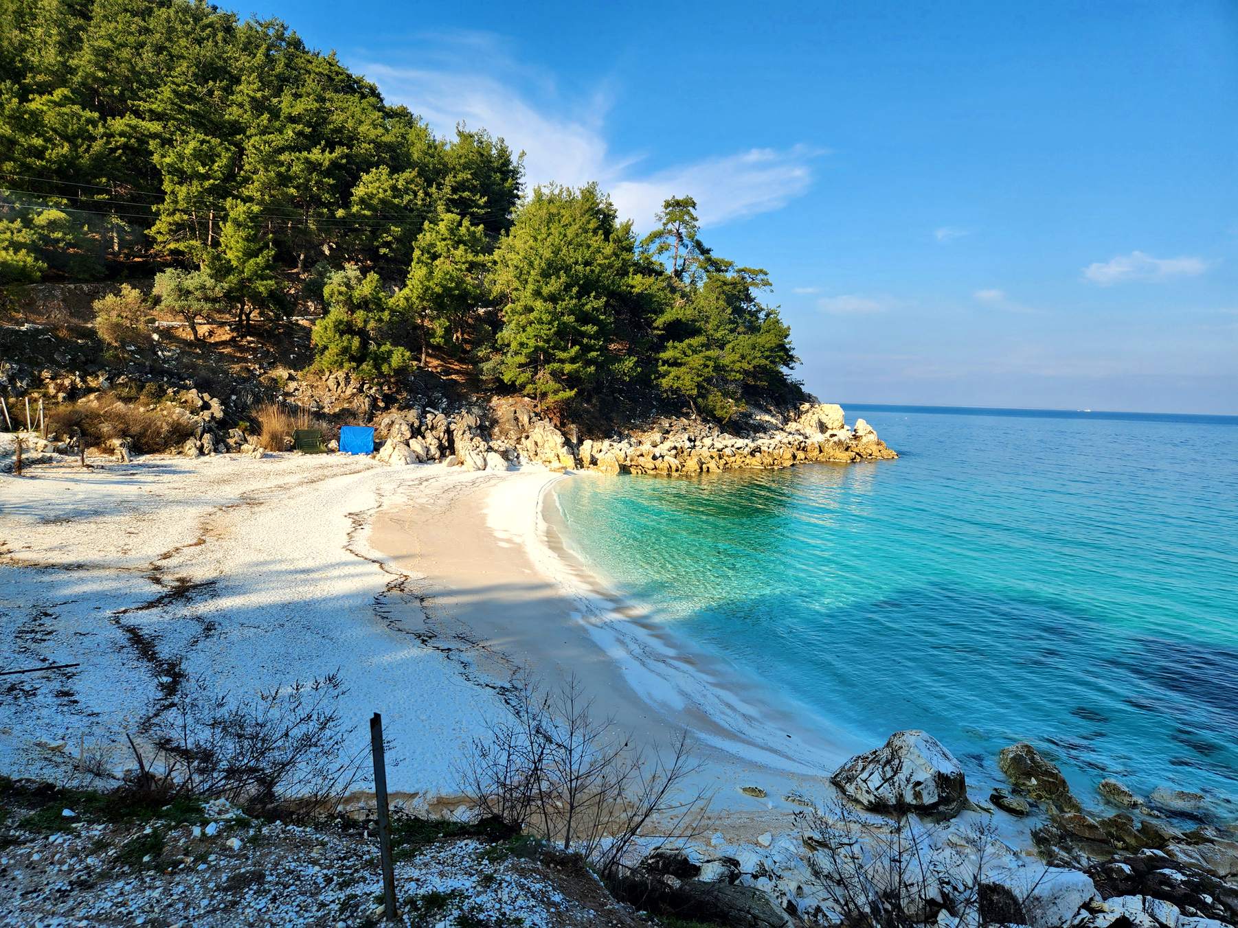 Turquoise water in a cove of white marble pebbles
