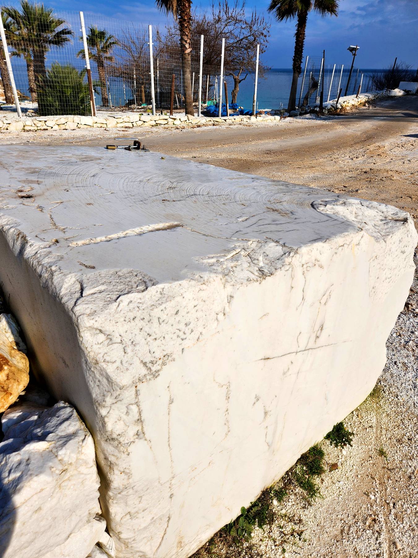 A big block of white marble by the beach