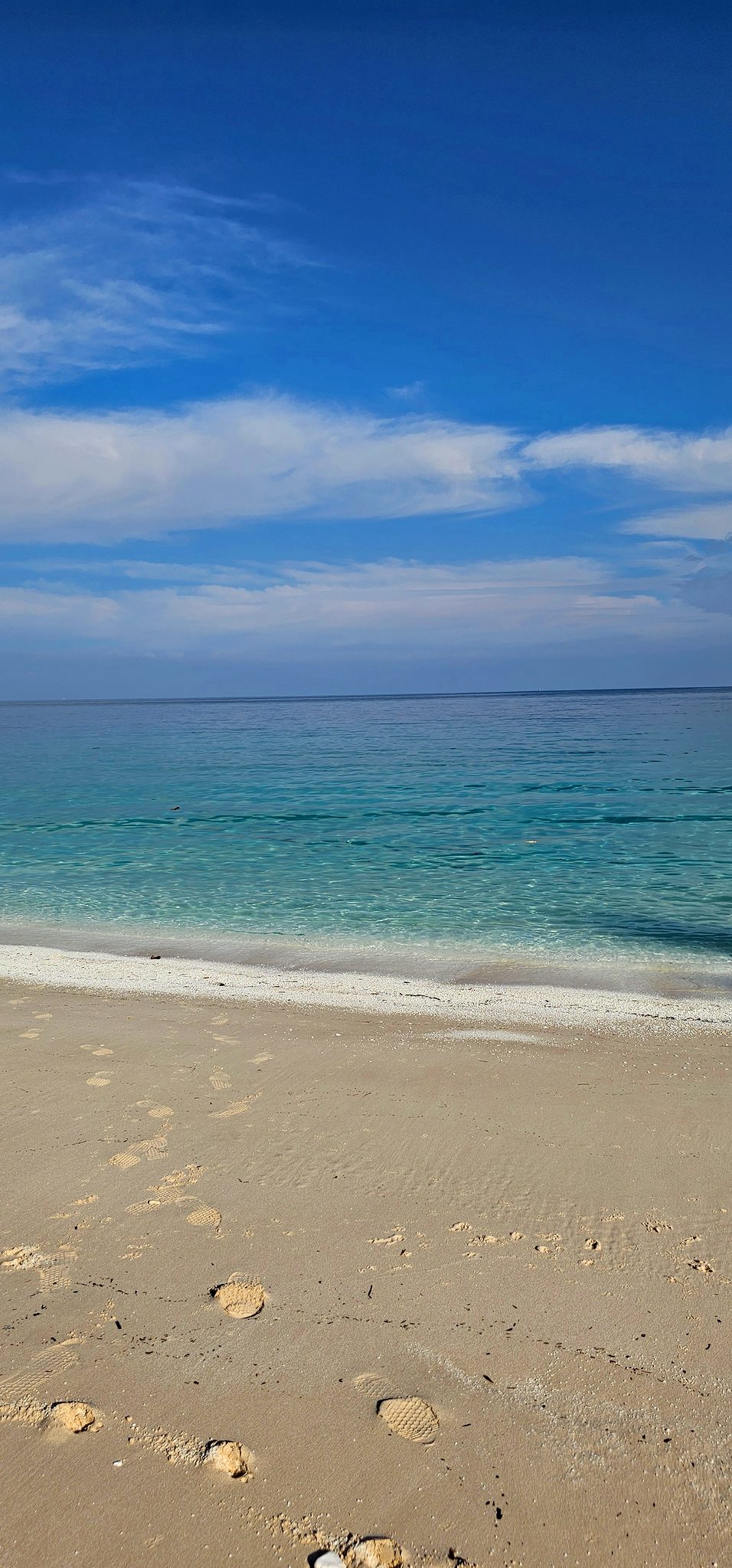 Clear water at the edge of the white shore