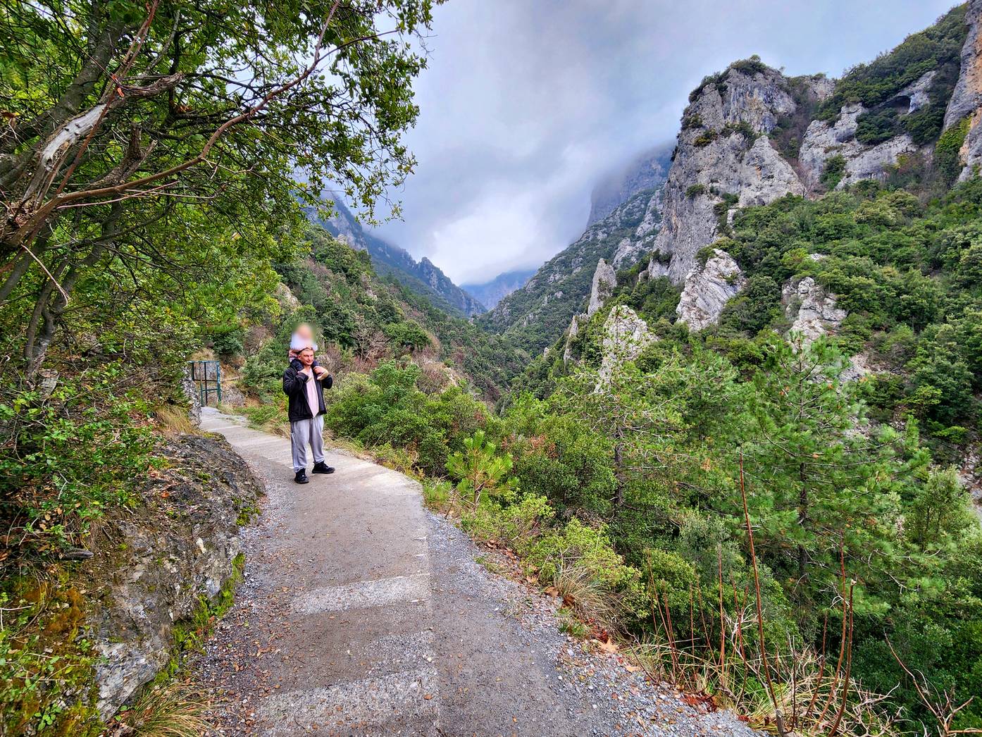 Paved trail winding between cliffs