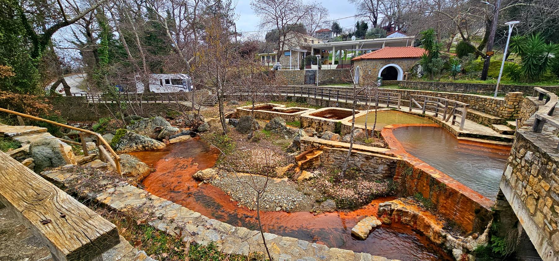 Old stone pools stained orange by iron-rich water