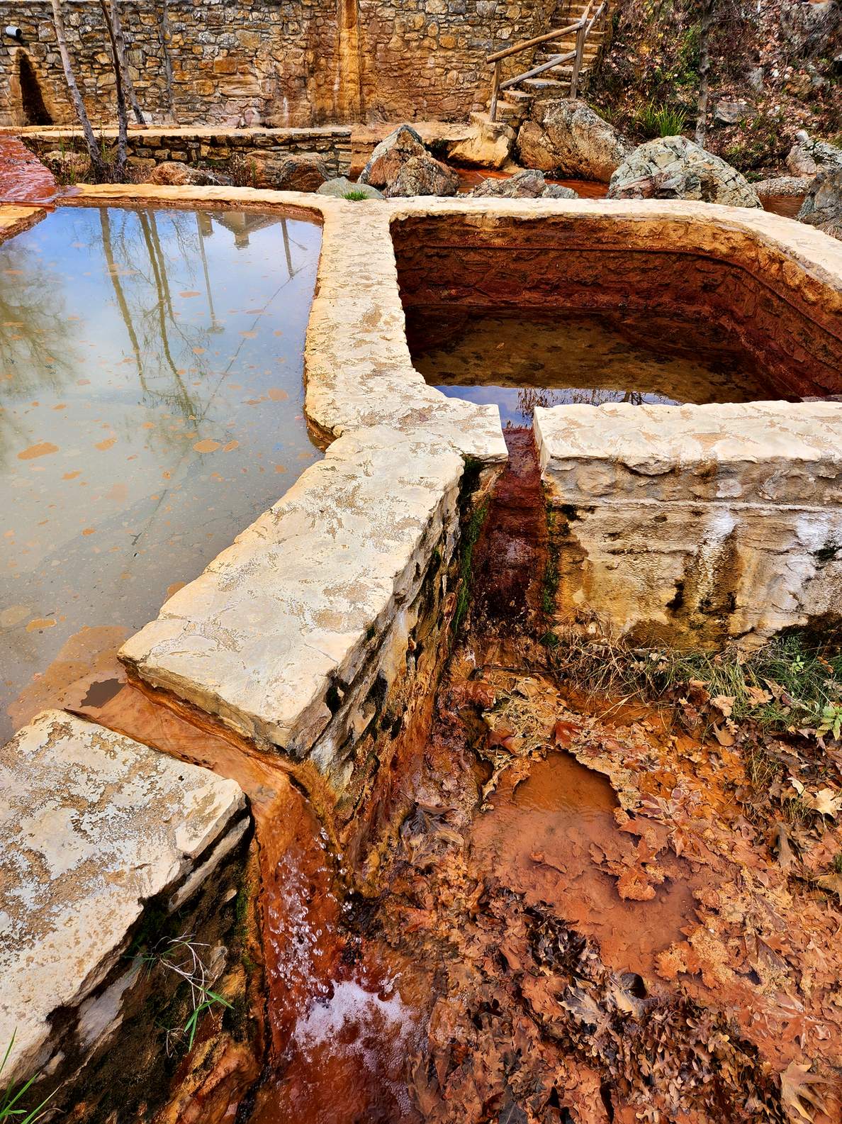 Rust-red water in stone channels