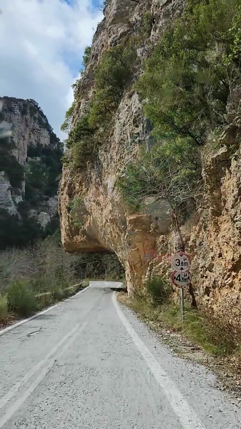 Camper road running through a tunnel cut into the rock on the Langada Pass