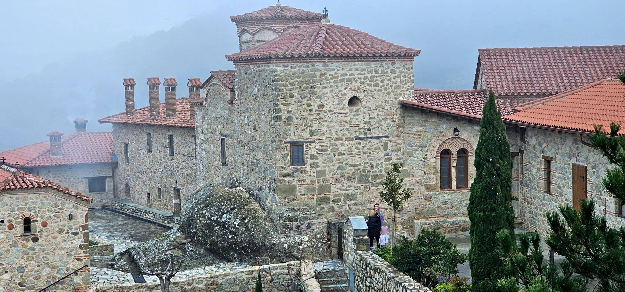 Red roofs and stone walls in the mist