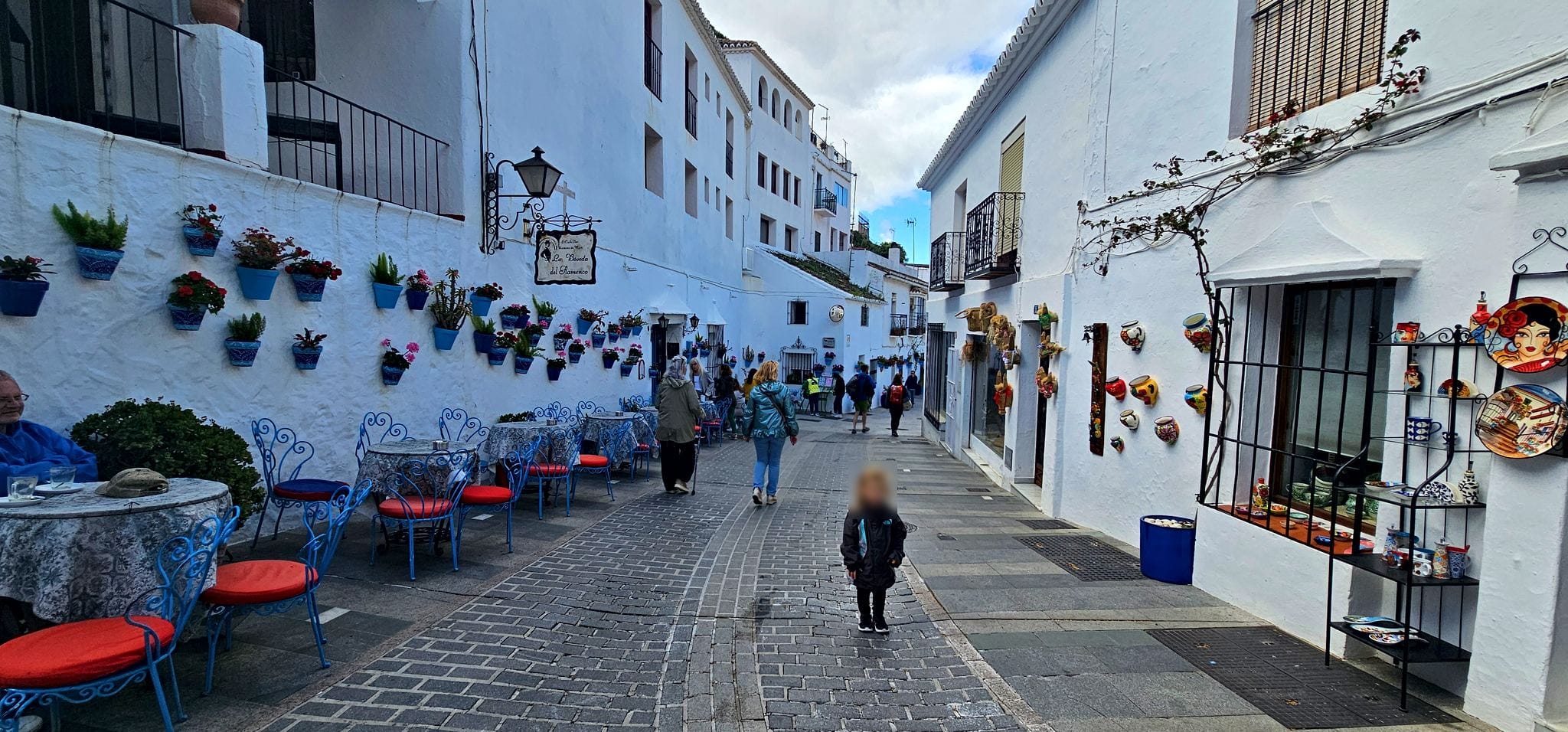 Whitewashed street with flower pots in Mijas, Spain