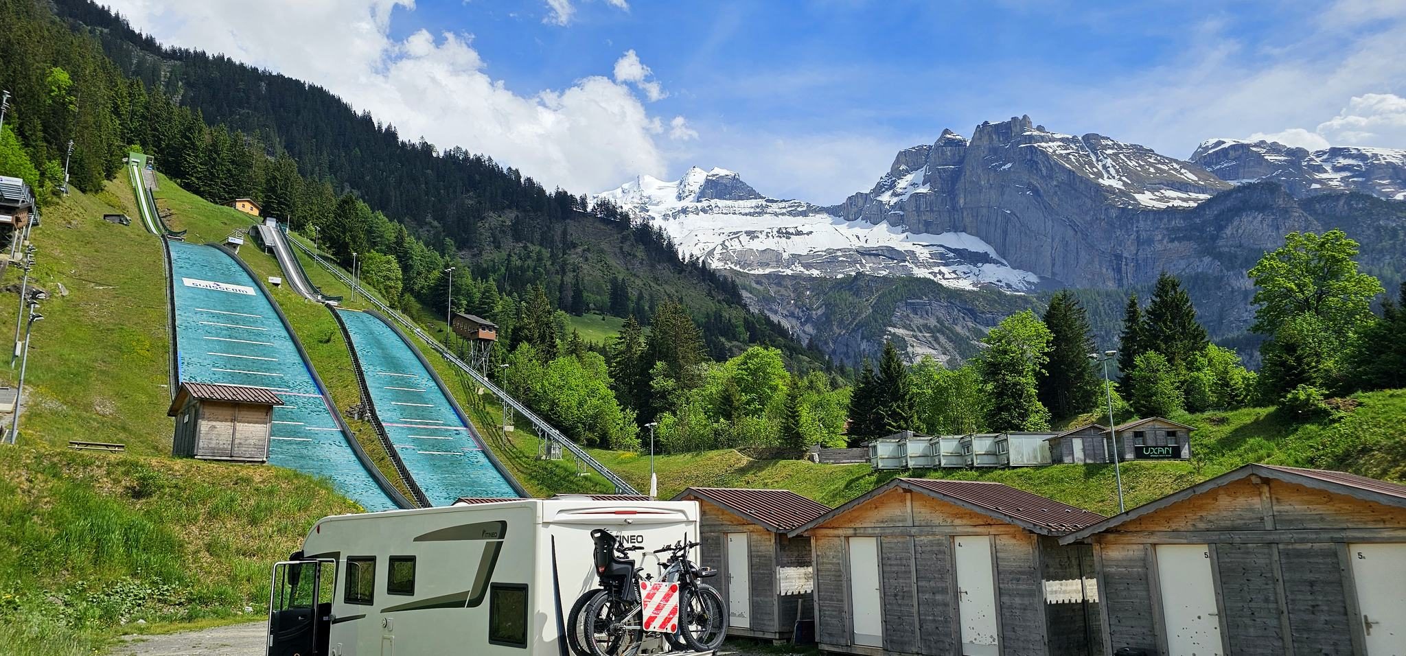 Our camper with bikes on the back, parked below the Kandersteg ski jumps